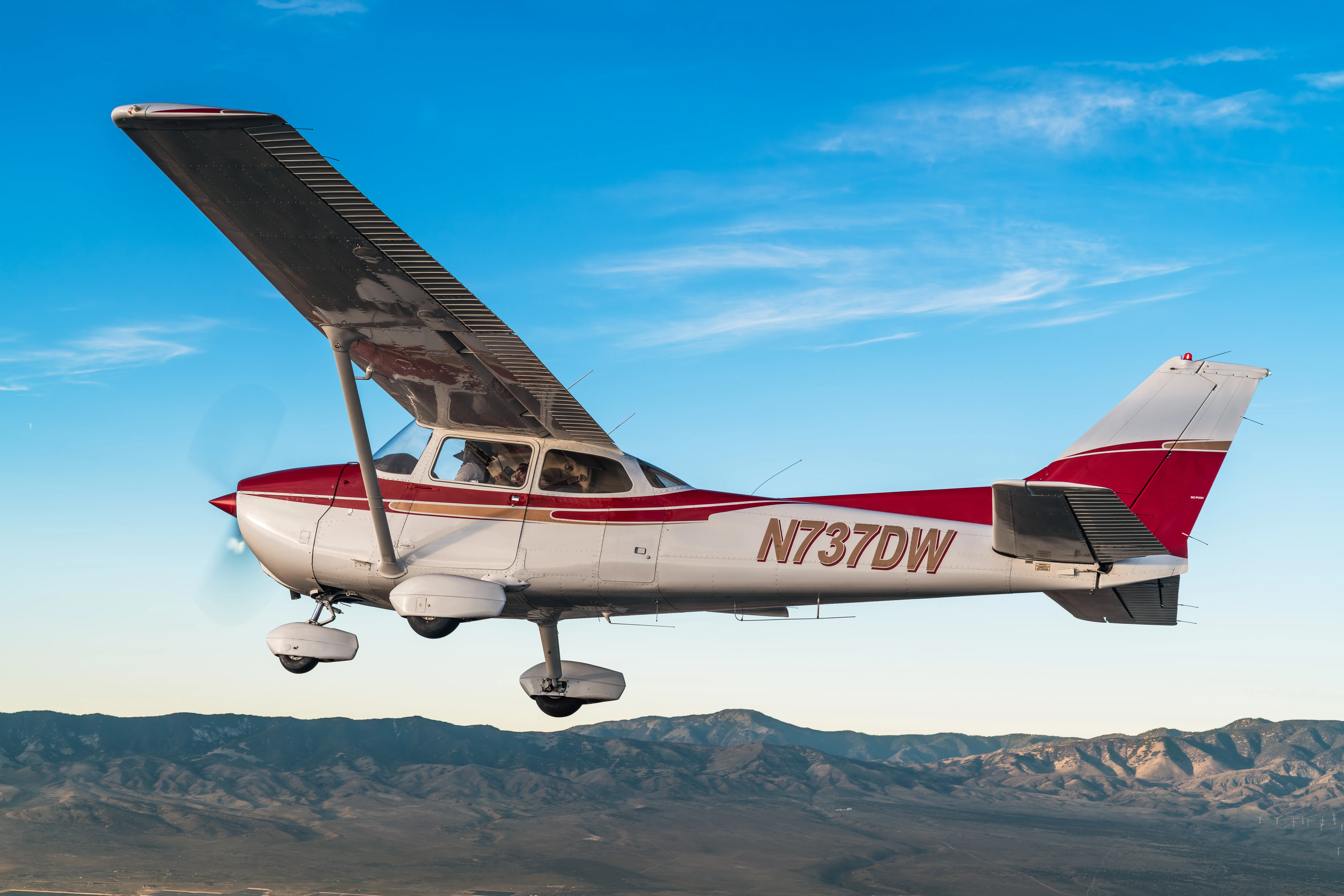 Commercial pilot student reviewing flight plan in cockpit at MH Aviation