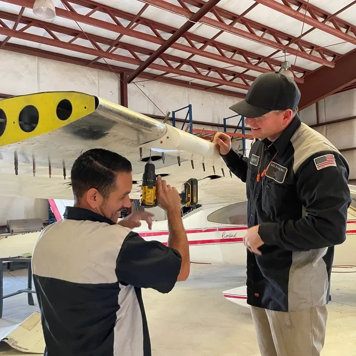Mechanics working on aircraft engine
