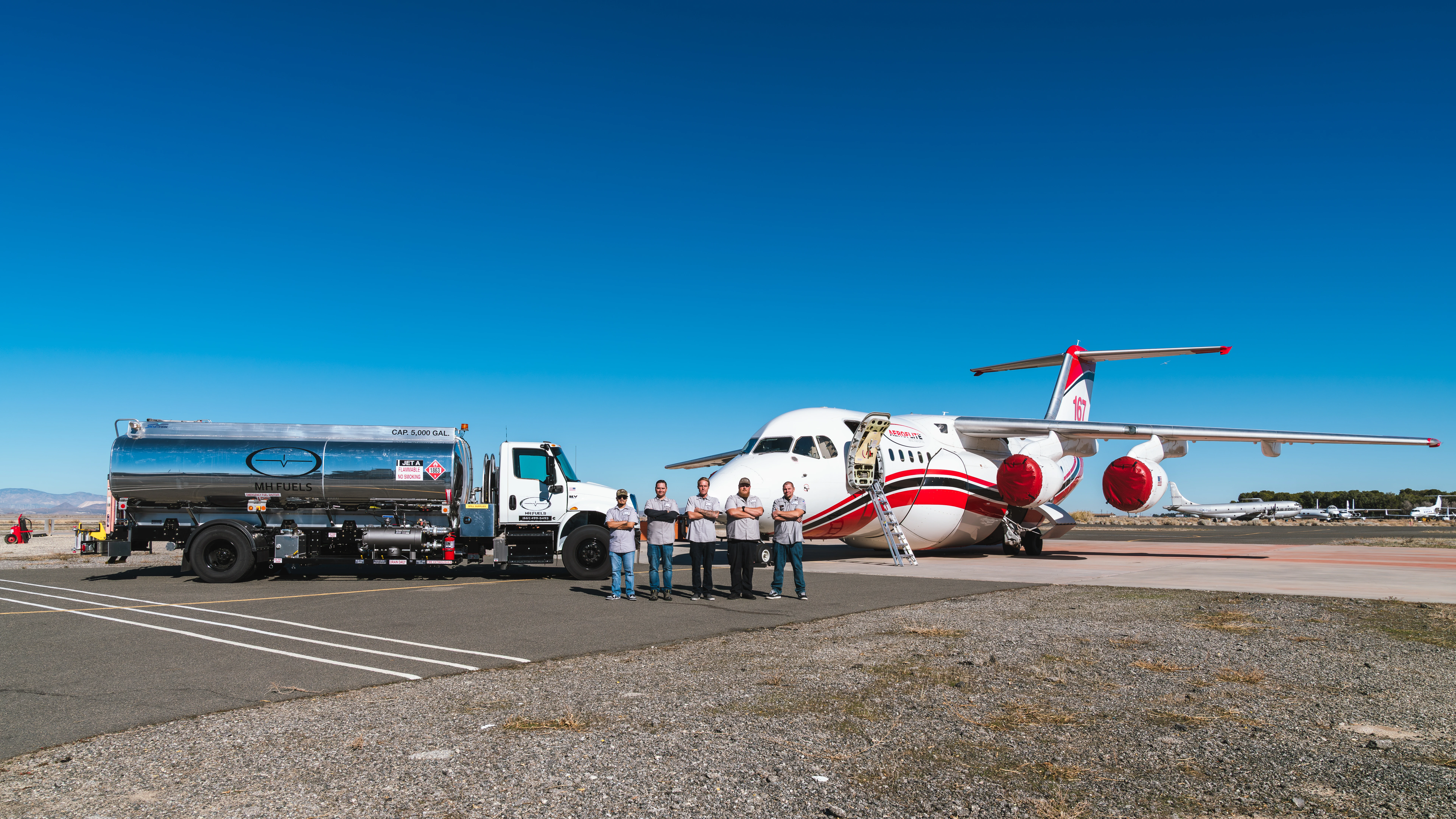 Wide shot of the professional service team at MH Aviation at Lancaster, California