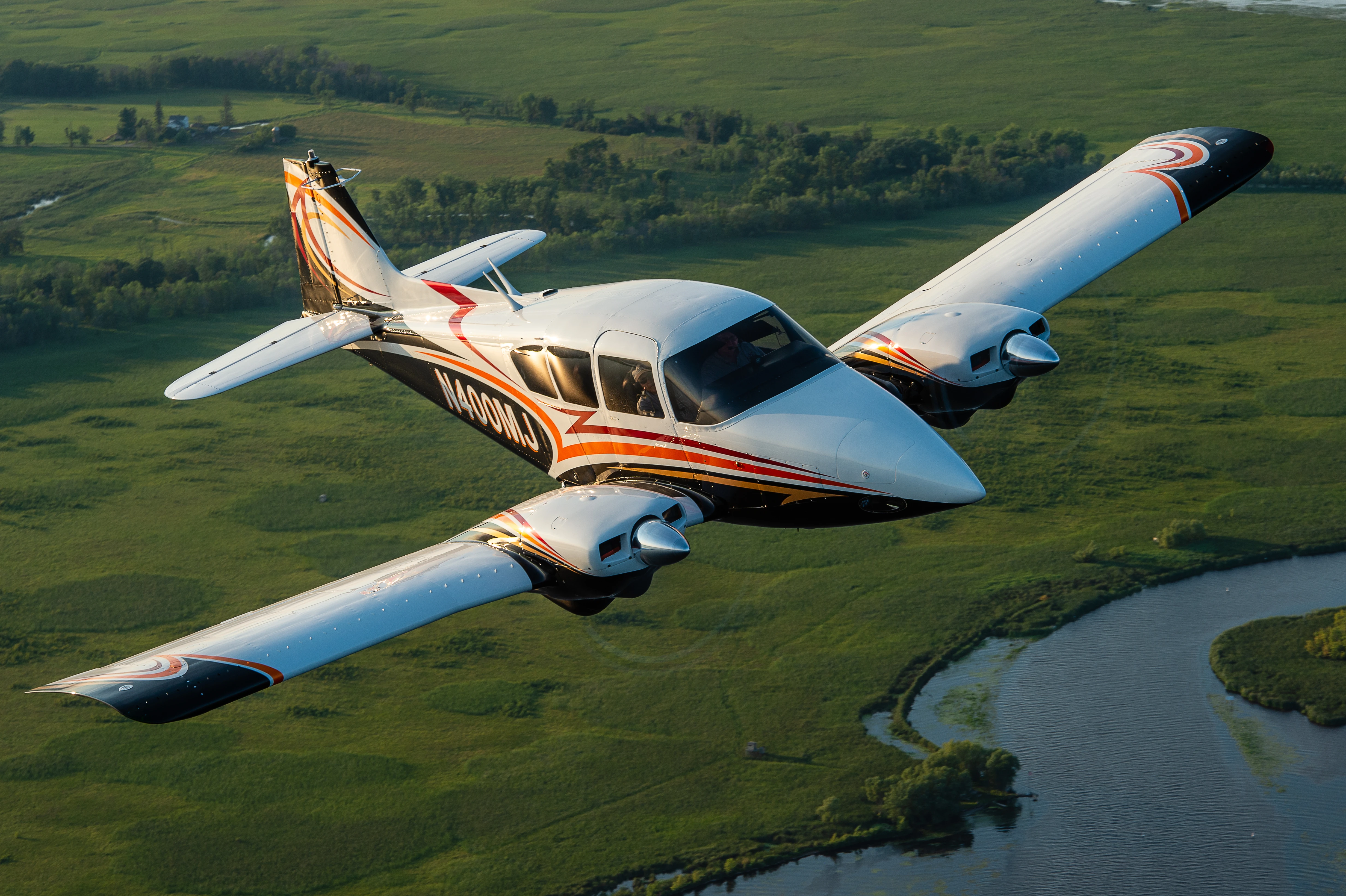 Geronimo aircraft flying over green fields at Lancaster, California at MH Aviation