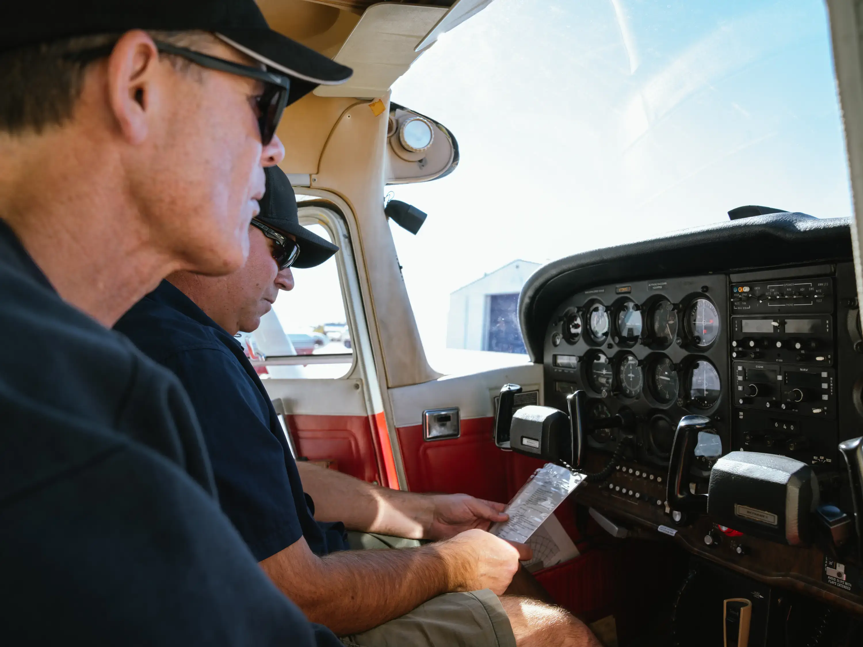Instructor with student inside cockpit at MH Aviation at Lancaster, California