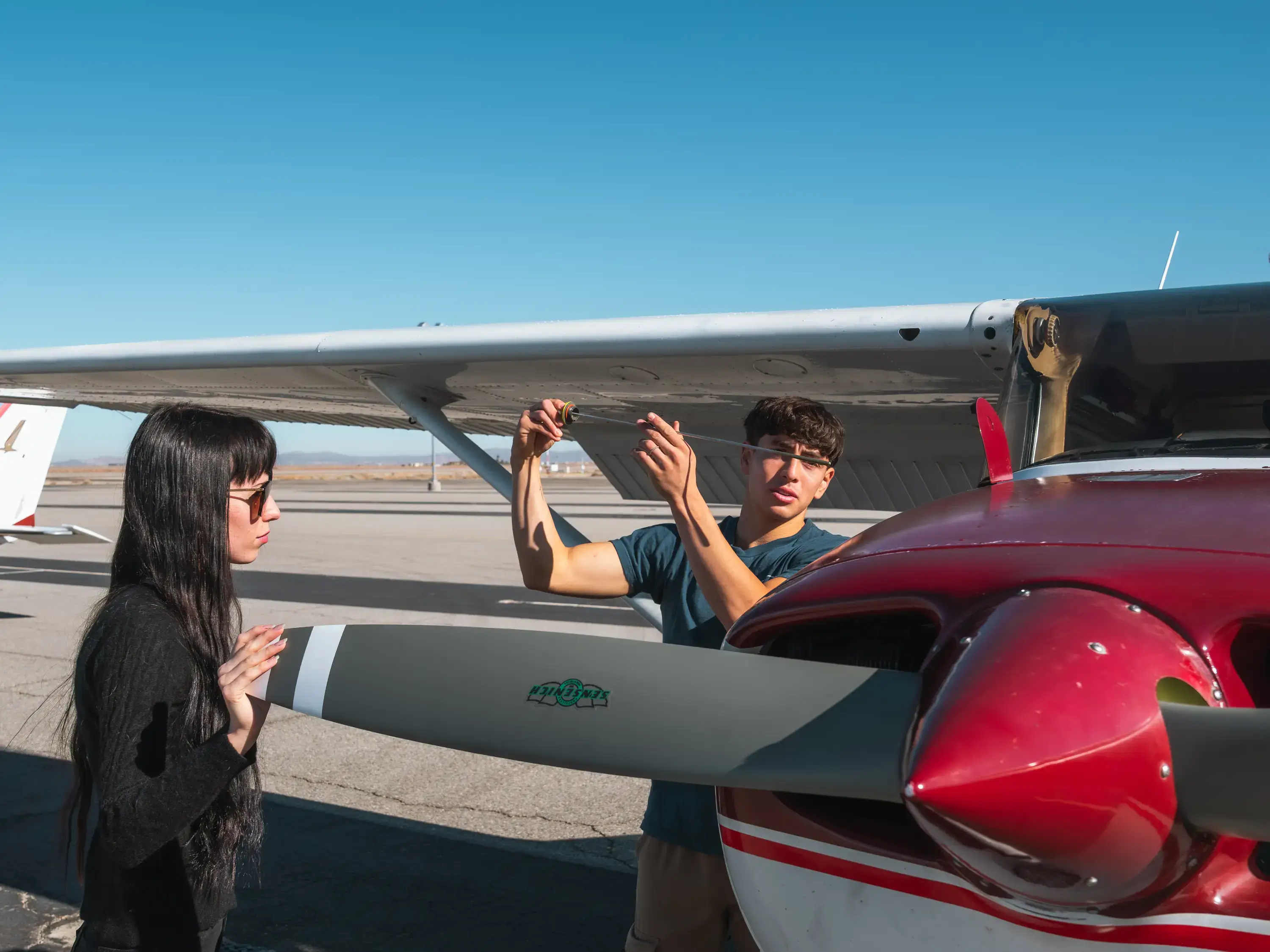 MH Aviation instructor and student inspecting front wing