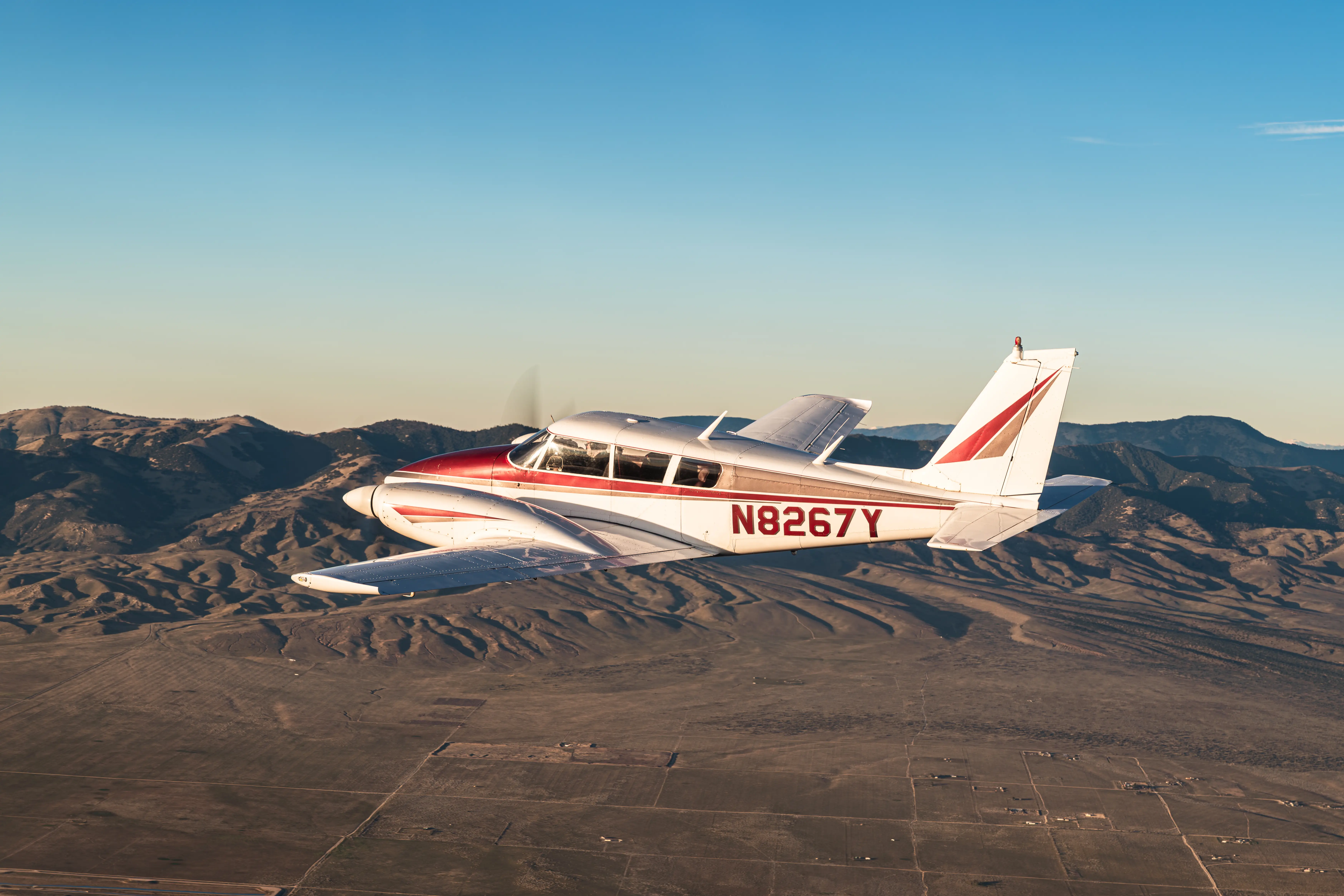 View of the Piper flying over the montains